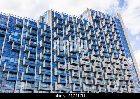 Modern high rise building facade with repeating geometric balconies Stock Photo