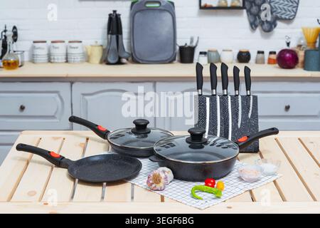 Various Cookware On Rustic Table. Cooking Utensils Spread On Wooden Surface Today Stock Photo