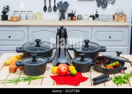 Chic And Durable Stone Cookware With Lids And Handles Displayed On Contemporary Kitchen Countertop Stock Photo