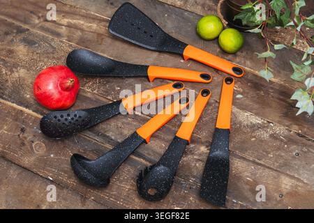 Closeup View Of Vibrant Cooking Utensils Organized On Rustic Wooden Board For Meal Preparation Stock Photo