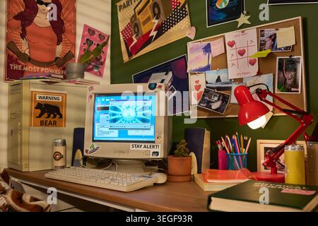 Desktop computer displaying retro interface on creative workspace, featuring mood board and study tools, representing nostalgic digital culture. Useful for youth marketing or tech trends Stock Photo