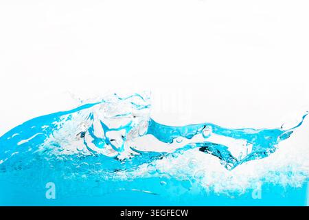 Blue water splashing creating bubbles and wave motion Stock Photo