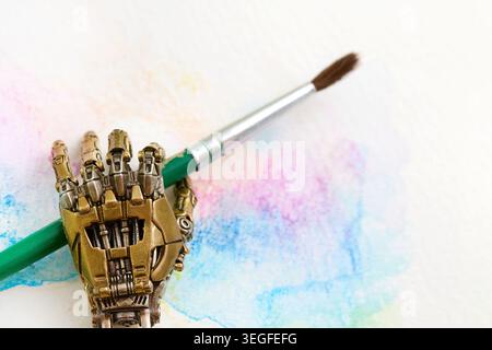 Robotic hand holding paintbrush creating watercolor art Stock Photo
