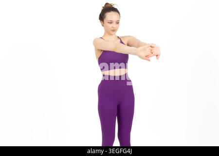 Young healthy woman stretching her arms behind her back Stock Photo
