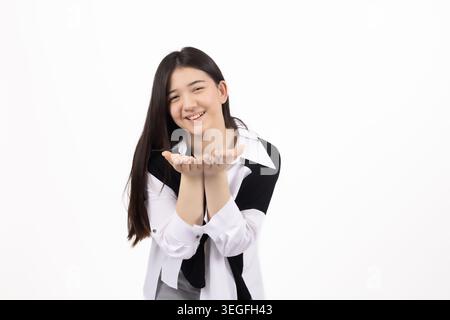 Young thoughtful woman looking at camera with hands on hips Stock Photo