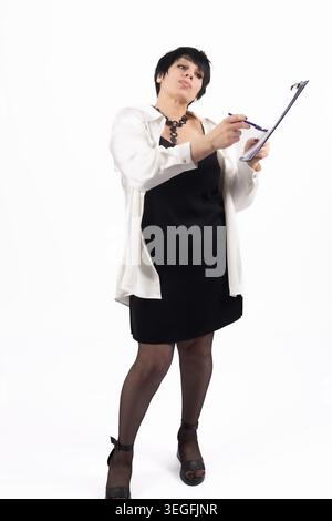 Business woman standing with folder and clipboard taking notes isolated Stock Photo