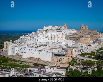 Ostuni, the White City of Puglia. Aerial drone view of panorama of historic Italian architecture and Mediterranean landscape. Whitewashed old town Stock Photo