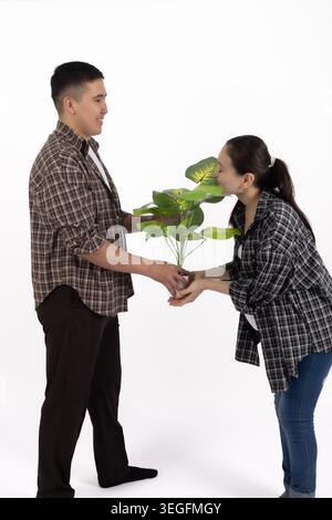 Happy young man and woman shaking hands standing isolated white Stock Photo