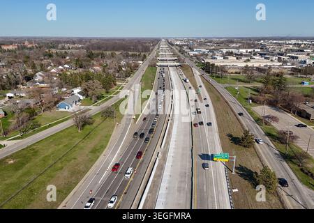 Aerial view of long highway passing through green country fields Stock Photo