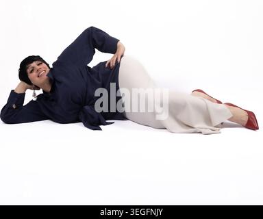 Young man lying on floor and relaxing with hands behind head Stock Photo