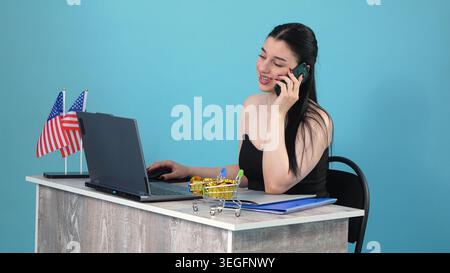 Business woman talking on mobile smartphone working at office desk Stock Photo