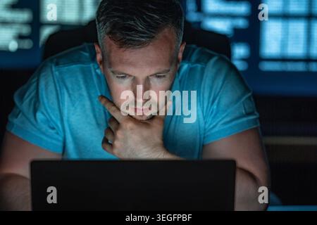Focused cybersecurity specialist monitors digital threats and protects sensitive data. Stock Photo