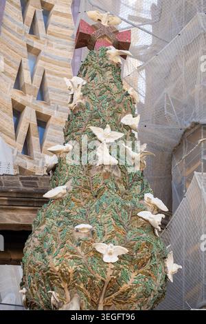 BARCELONA, SPAIN - MAY 19, 2026: Detail of the stone sculpture depicting the Tree of Life cypress with white marble doves on the Nativity Facade of th Stock Photo