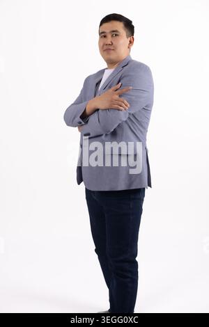 Confident businessman standing with hands in pockets looking camera Stock Photo