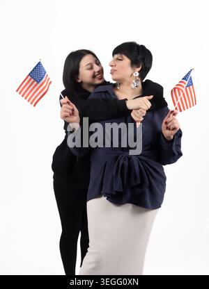 Patriotic multiethnic business team standing together near national flags Stock Photo