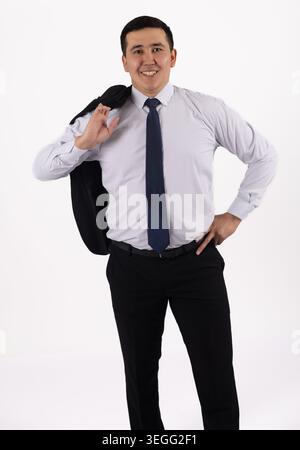 Smiling handsome man walking and holding jacket over shoulder Stock Photo