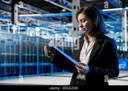 Augmented reality wireframe mesh mapping, system benchmarks results and manager in server farm. Infrastructure digital twin scan and specialist reading documents in data center Stock Photo