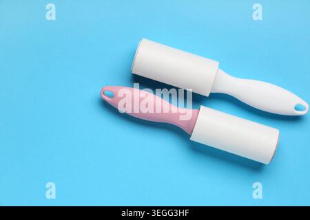 Sticky lint rollers on blue background Stock Photo