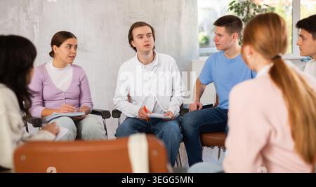 Group of students preparing for exam together in classroom of college Stock Photo