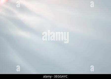 Bright abstract background with a soft light leak and gentle diagonal waves in pale tones Stock Photo