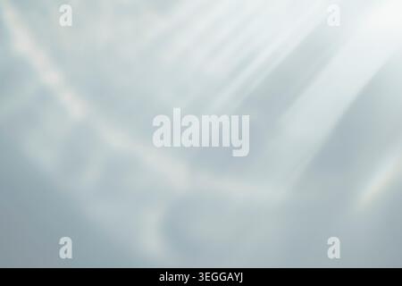 Soft abstract background featuring bright diagonal sunbeams and gentle blurred textures in pale tones Stock Photo