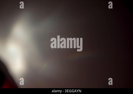 Deep dark abstract background illuminated by a soft white light leak and subtle holographic reflections Stock Photo