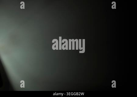Minimalist smooth dark background with subtle green gradient light and heavy vignette Stock Photo