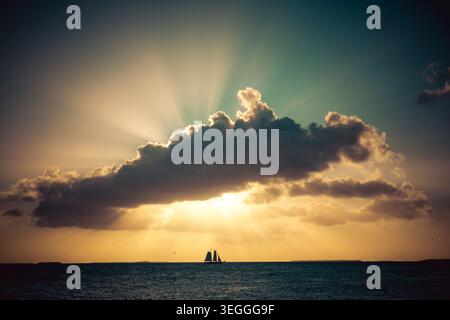 Florida sunset colors and rays of ligth and a boat Stock Photo