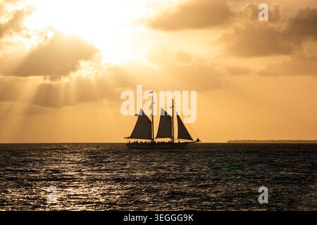 Shadow of a boat in front of florida's sunset Stock Photo