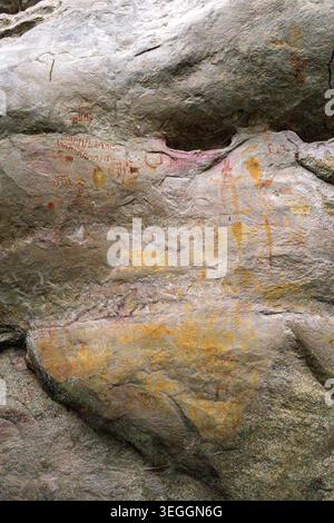 Colorful pictographs on rocky surface displaying various ancient symbols. Stock Photo