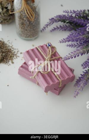 Handmade lavender soap on a white table with lavender and herbs Stock Photo