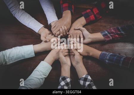 Group of Christians diverse hands holding hold hands circle to pray for God each other support together teamwork. Top view. Stock Photo
