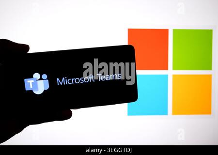 In this photo illustration, a Microsoft Teams logo is seen displayed on a smartphone with a Microsoft logo in the background. Stock Photo