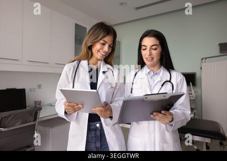 Two healthcare professionals working together at hospital office Stock Photo