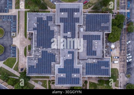 An overhead nadir aerial drone photograph looking directly down onto a solar panel array installed on a University of New Orleans building rooftop Stock Photo