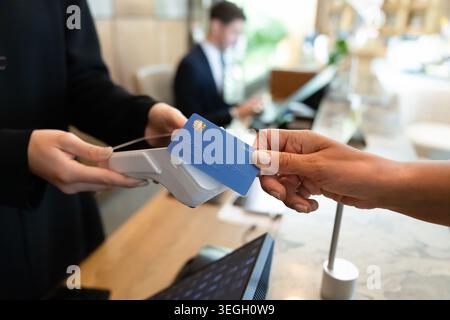 Customer making contactless payment at retail counter Stock Photo