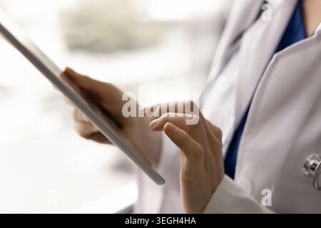 Closeup of female doctor hands holding digital tablet Stock Photo