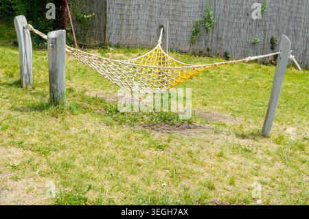 Hammock in the garden. Hanging hammock in the garden. Hammock made of ropes. Natural design Stock Photo