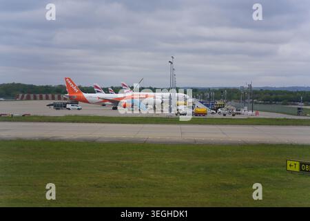 easyJet aircraft parked on the tarmac with ground vehicles at London Gatwick Airport, England Stock Photo