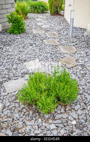 Gravel path and rocks in landscaped garden Stock Photo