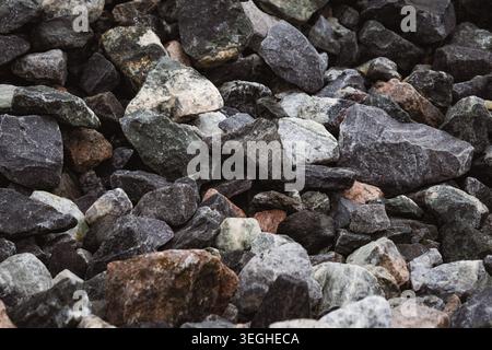 Natural rock formation with rugged gray and brown tones textured stone surface featuring sharp, layered edges and earthy details, isolated on white ba Stock Photo