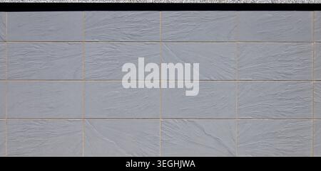 Elegant large gray rectangle stoneware tiles with slate effect. Background and texture. Stock Photo