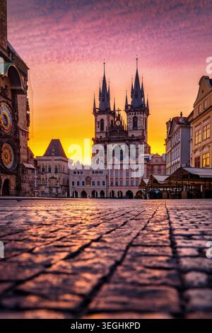 Low angle summer sunrise view of the old town square at the city center of Prague, Czech Republic, with Tyn Church and Astronomical Clock Stock Photo
