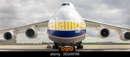 Schkeuditz, Germany - 9 May, 2026.Front massive Antonov AN-124 Ruslan cargo aircraft parked on airport apron under dramatic cloudy sky Stock Photo