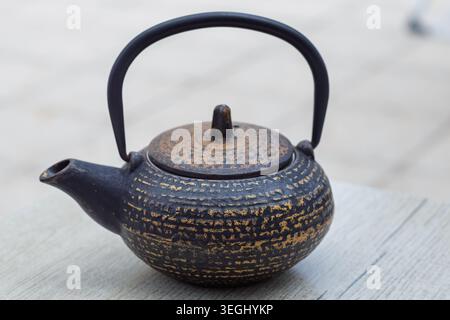Traditional japanese cast iron teapot with rustic texture for serving tea Stock Photo