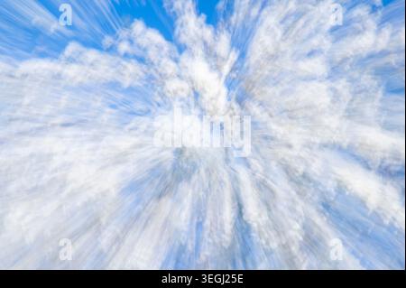 Abstract blurred background with white bokeh dots on a soft blue sky.  Stock Photo