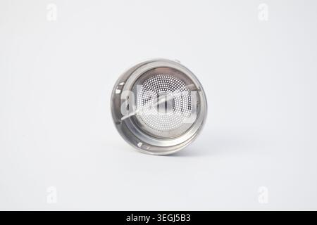 Stainless steel tea infuser strainer basket isolated on a white background. Stock Photo