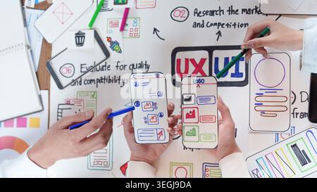 Asian design team collaborating on UX UI mobile app interface mockups Stock Photo