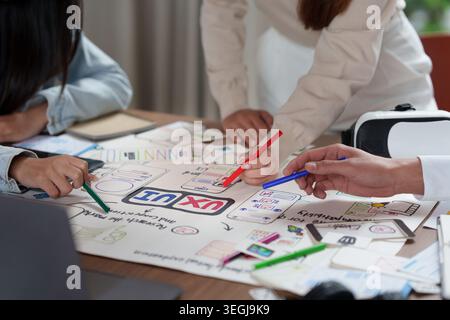 Three people collaborating on UX UI design for mobile app development Stock Photo