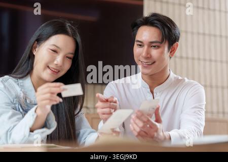 Asian man and woman designers discussing mobile application design in modern office Stock Photo